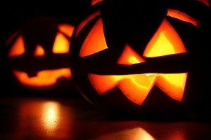 Photo of two Halloween jack-o-lanterns glowing in the dark.