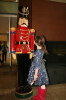 [image] Little girl with a large nutcracker statue [image]
