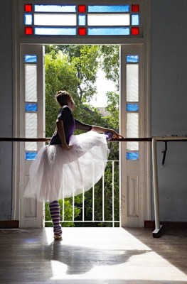 Jim-Markland-Rowbotham-window-dancer IMAGE Dancer Grettel Morejon of Ballet Nacional de Cuba stretches at the barre. Light streams through her skirt as she stands before a sunlit window. IMAGE