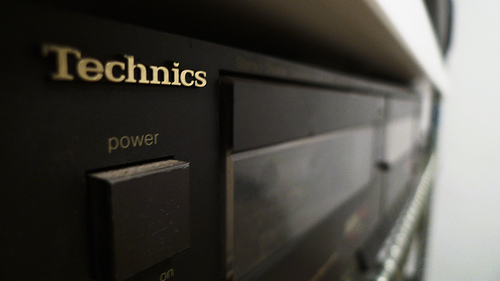 Cassette Deck IMAGE Close visual of the power button and cassette deck of a Technics music stereo component. IMAGE
