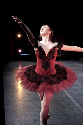 Paquita-SimoneBoos IMAGE During a production of Paquita, from the wings we glimpse a college ballerina performing. IMAGE
