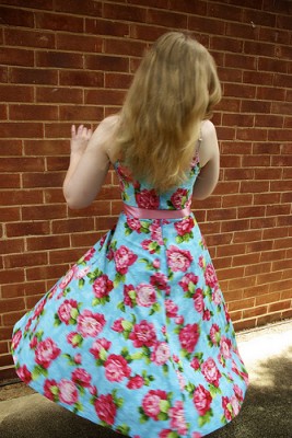 IMAGE A girl twirls in a pretty rose-print dress. IMAGE
