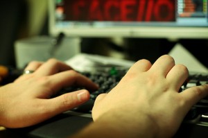 Photo of female hands typing on a computer keyboard