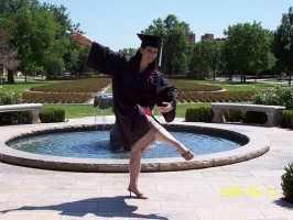 IMAGE A dancer poses in her cap and gown. IMAGE