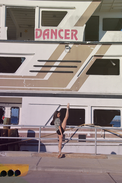 Photo of a dancer in front of a ship called Dancer
