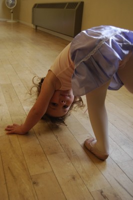 Photo of a little dancer posing upside-down