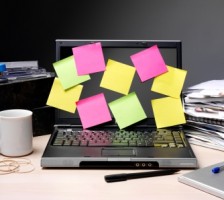 A laptop with sticky notes all over the screen.