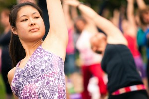 Closeup of a young woman reaching overhead in a yoga pose