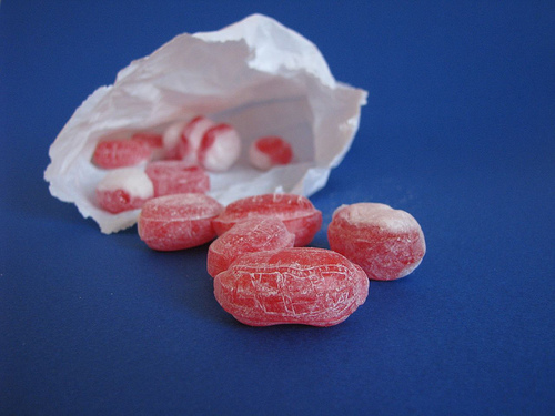 [image] This image of strawberry hard candy tumbling out of a wrapper is your link. [image]