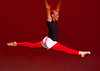 IMAGE A dancer in red tights does a split leap. IMAGE