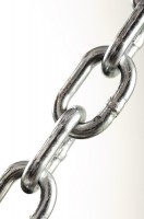 IMAGE Close-up of metal chain links against a white background. IMAGE