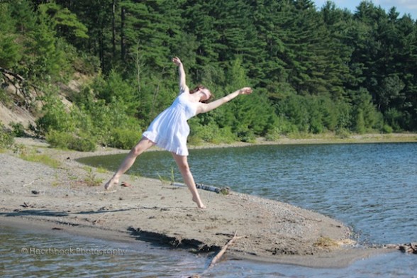 IMAGE A dancer moves with abandon on the rocky shore of a lake. IMAGE