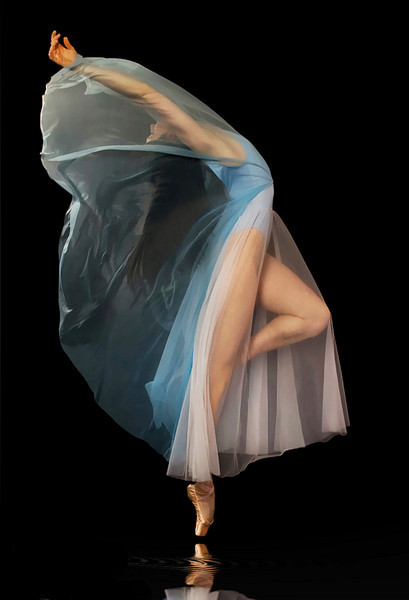 IMAGE A ballet dancer in white chiffon arches her back as sheer blue fabric billows back over her face and arms. IMAGE