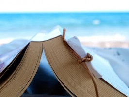 IMAGE Reading a book at the beach IMAGE