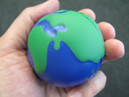 IMAGE An 'Earth' stress ball is held gently in someone's hand. IMAGE