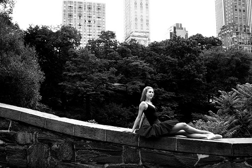 IMAGE A ballet dancer lounges on a stone wall in Central Park, New York City. IMAGE