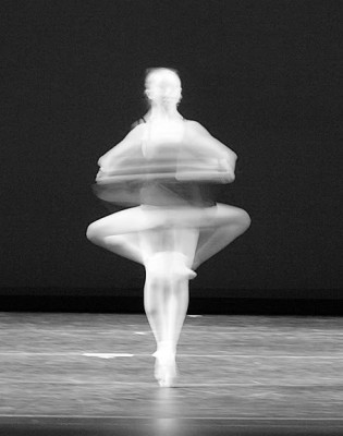 IMAGE A blurred figure is captured in a pirouette. IMAGE