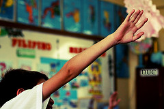 IMAGE A young student raises hand in class IMAGE
